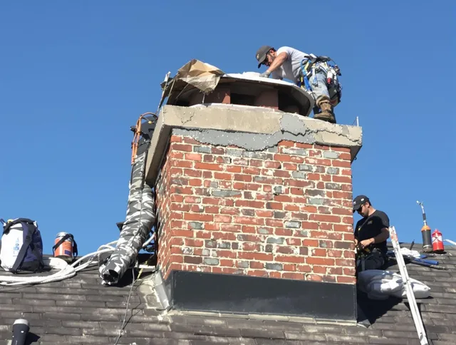Pompano Beach Chimney Sweep installing a custom chimney crown in Pompano Beach, FL